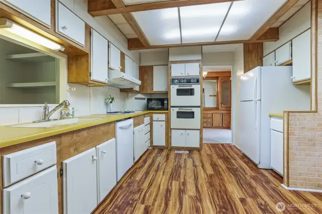Spacious kitchen with an eating area and laminate floors.
