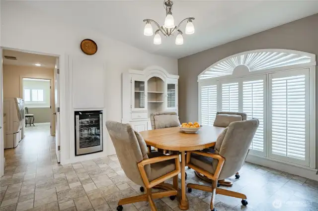 Nook area on one side of the kitchen. Enjoy the shutters. See one beverage cooler.