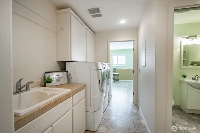Utility room just off the kitchen with access to the crafts room, half bath and garage.