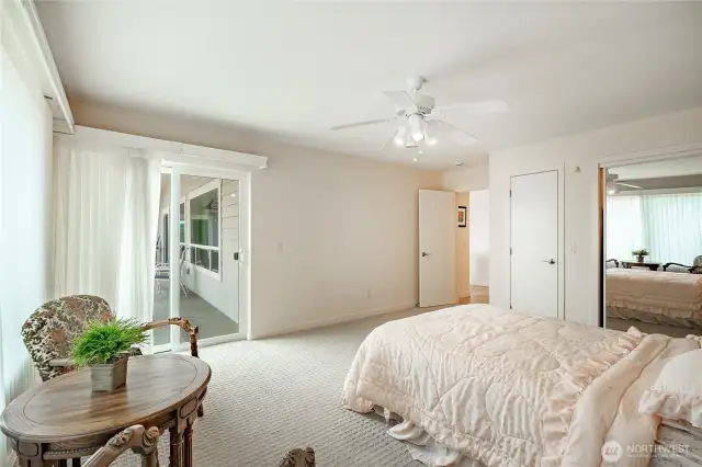 The other guest bedroom on the main level with access to the deck. Walk-in closet just outside this room.