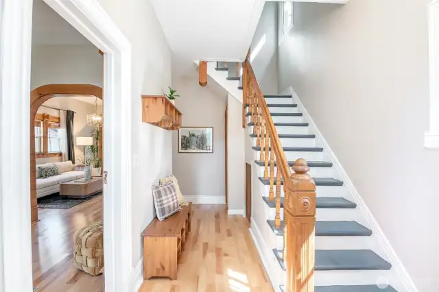 The entry features this gorgeous staircase with lovely newel posts. Lots of room to store outerwear including a coat closet under the stairs.