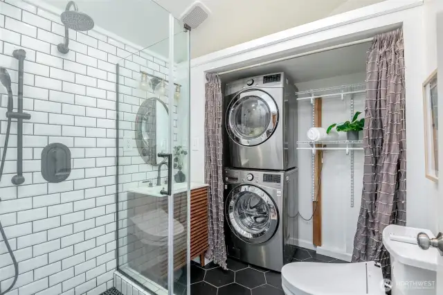 The main floor bath has beautiful tile, heated floors, and bidet. Convenient stackable washer and dryer with ample shelving for your laundry needs.