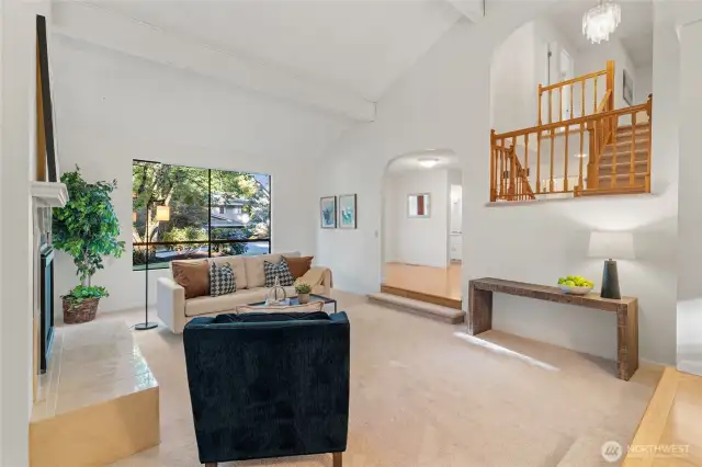 Entertain in style or unwind in peace—The large picture window frames the front yard, while the open staircase adds dimension and character to the two-level design. And just look at those beautiful archways!
