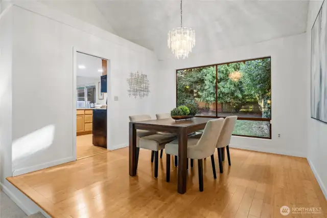 The dining room is thoughtfully elevated just a step up, creating a sense of separation and intimacy—while still maintaining an open, connected flow to both the living room and kitchen.
