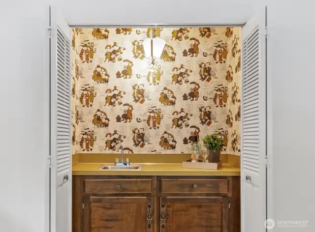 Party zone activated! Tucked behind folding doors, this charming wet bar is ready when you are—just pull back the doors and kick off the celebration in style.