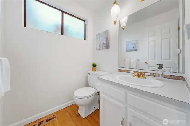 Tucked just off the entry, this timeless powder room adds both style and convenience—reflecting the character and thoughtful design found throughout the home.