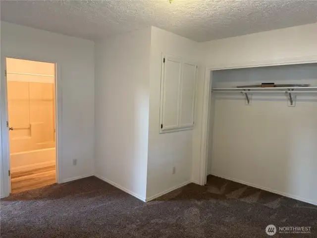 Primary suite. Note Wall cupboard designed to hold TV.
