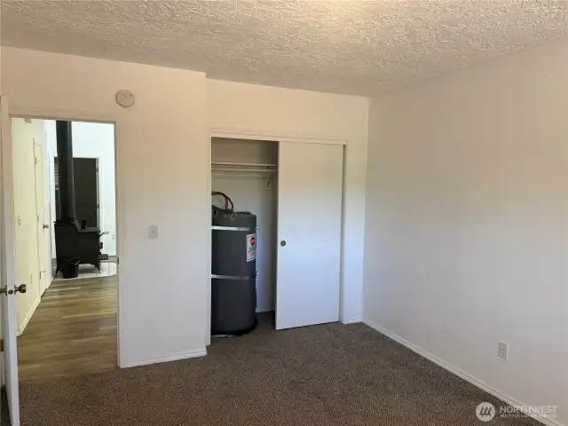 Closet has water heater. note this bedroom off of kitchen on opposite side of house from primary bedroom.