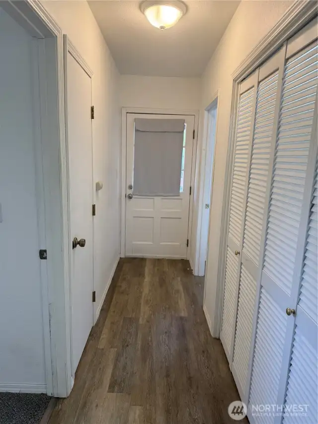 Hall to back deck, full bath and laundry closet.
