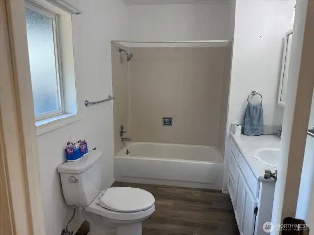 Full baht with tub and shower combo, end of hallway.