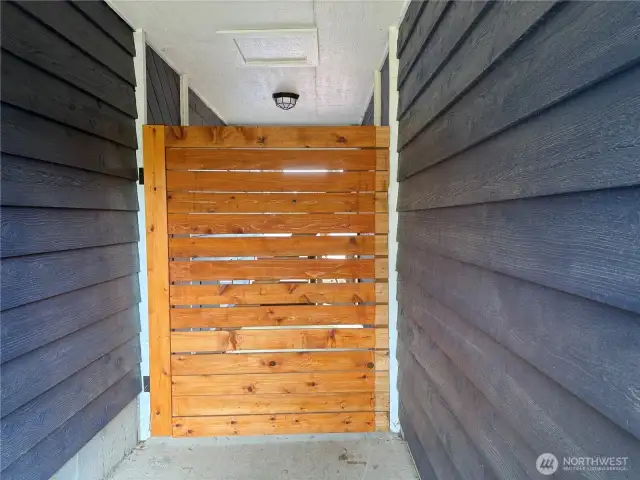 Outside between the house and the garage, privacy gate .