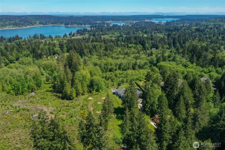 The trees standing near the perk holes are on this property. By removing them the view will be opened up nicely.