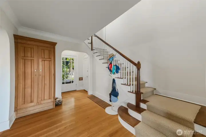 Unit B entry way with built in coat closet, new carpet on stairs.