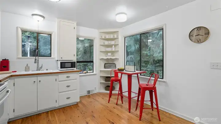 Cozy dining nook with built-in corner shelving adds charm and functionality.