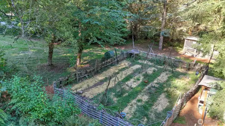 Expansive fenced garden space ready for planting and homesteading dreams.