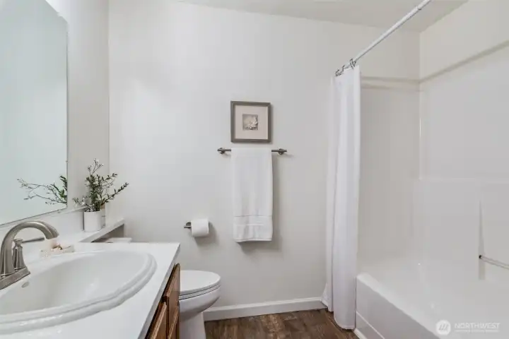New toilet and flooring in this bathroom.