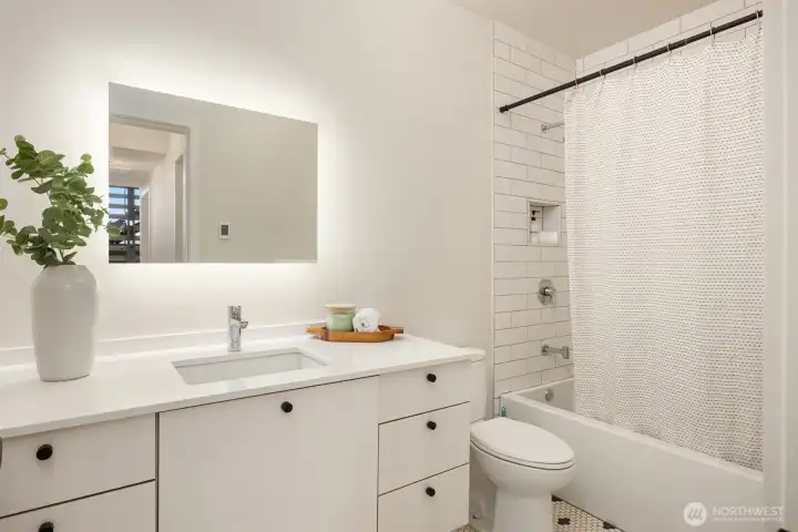 The full bathroom shared by bedrooms #2 and #3 boasts the same high-quality details and finishes