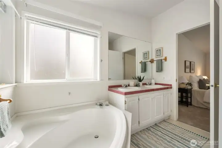 En-suite bath with large soaker tub and stand up shower