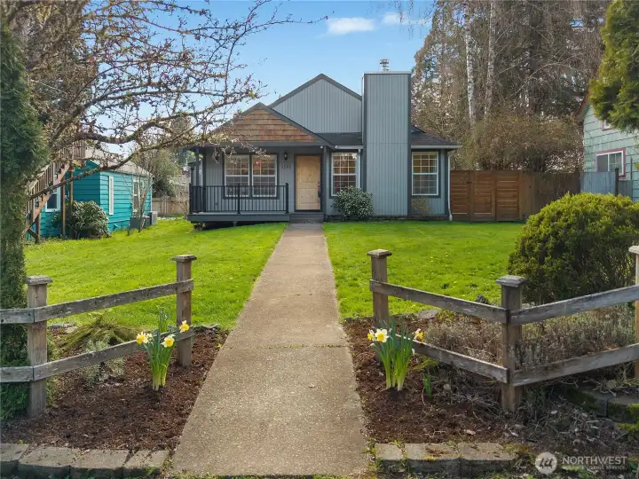 Welcoming front approach is framed by mature landscaping and a broad front lawn.