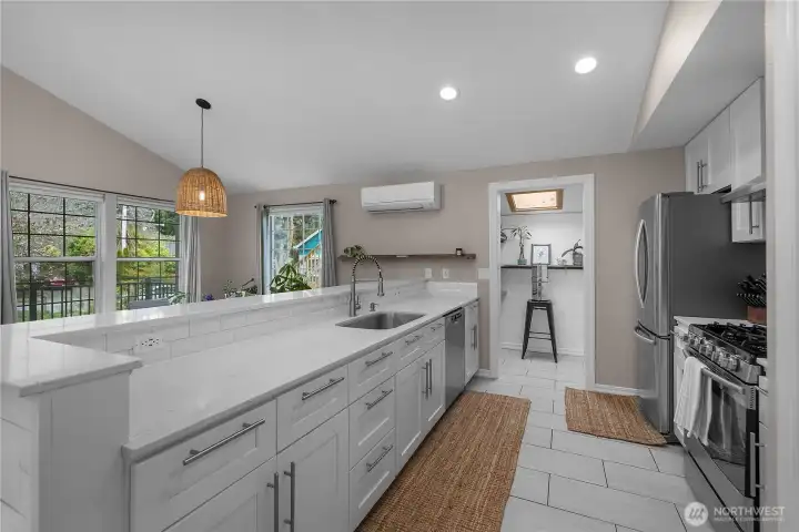 Updated kitchen features quartz counters, stainless appliances, and generous prep space.