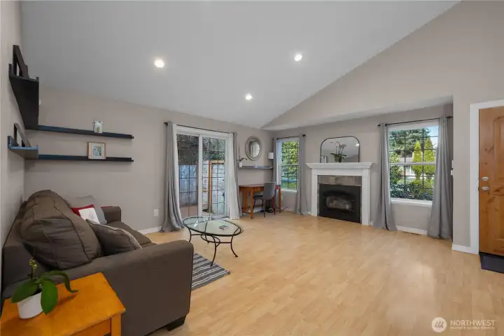 Vaulted ceilings and abundant natural light make the living room feel open and airy.