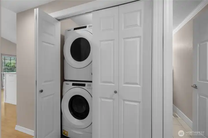 Stacked washer and dryer provide efficient laundry space without sacrificing storage or flow.