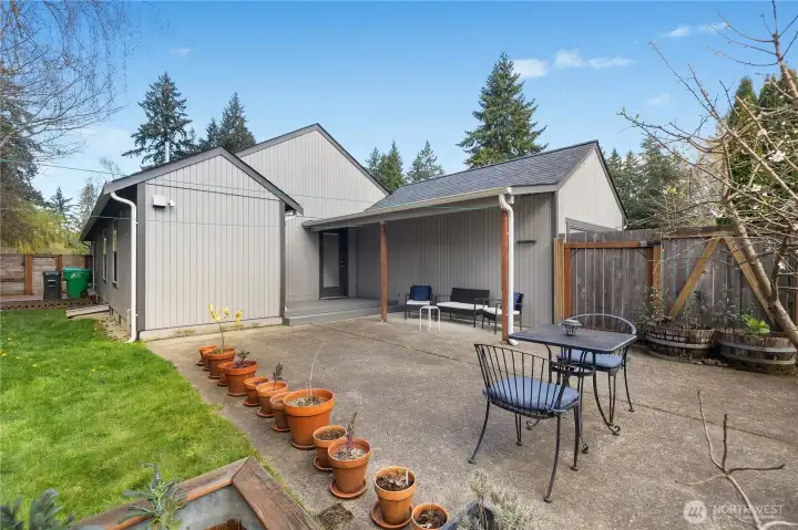 Private backyard retreat with covered entry, patio space, and detached garage access.