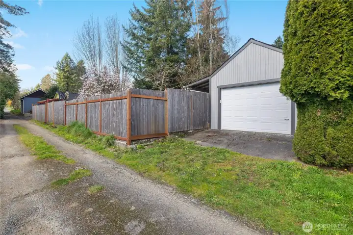 Rare alley-access garage provides practical parking and extra storage options.