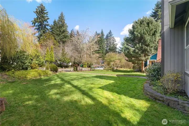 Generous front lawn and mature landscaping create a serene neighborhood setting.