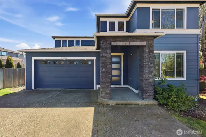 Spacious driveway and attached garage offering convenience, functionality, and additional parking flexibility.