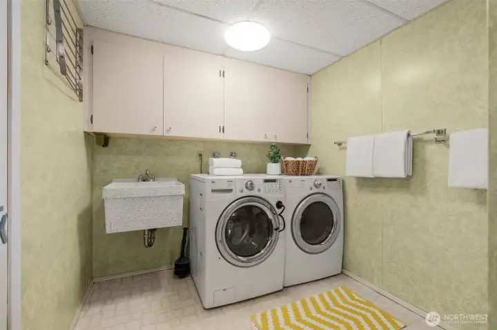 Separate laundry on the lower level, complete with utility sink.