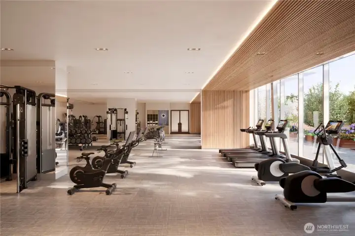Fully equipped fitness facility with expansive windows, cardio equipment with TVs, free weights, multi-gym system, towel service and water station.