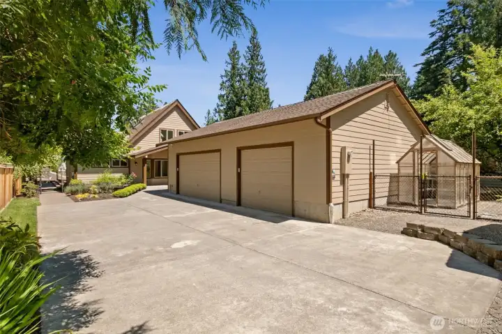 The impressive 40x25 detached 1,000-square-foot garage provides exceptional space for vehicles, recreational toys, hobbies, or a workshop, complemented by abundant driveway parking and an adjacent greenhouse for gardening enthusiasts.