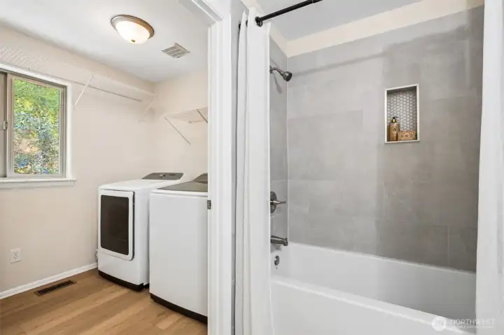 Conveniently located in the large main floor hall bathroom are the washer & dryer - and both stay with the home!
