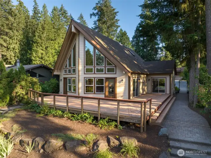 It may appear to be a charming cabin tucked among the evergreens, but this custom A-Frame lives much larger than expected!