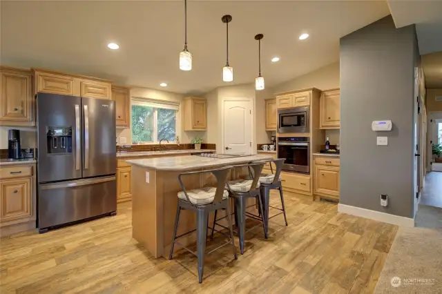 Spacious kitchen includes a breakfast bar, stainless steel appliances, a walk in pantry and tons of cabinets