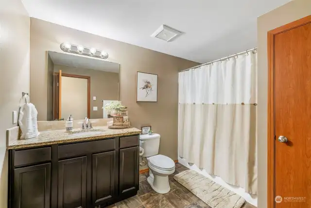 The main bath also features a granite countertop, and has a soaking tub/shower combination.