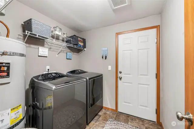 The laundry room has hanging space for the clean laundry and is also a mud room.
