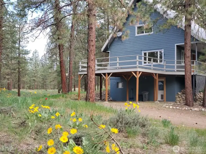 Winthrop Twin Lakes Home on generous 1 Acre lot. 3 bedroom and 2 bath. Hardwood floors. Wood trim throughout. 2 car Carport. Extra storage with 2 outbuildings.