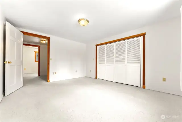 Primary bedroom Upper level of home is carpeted. Large closet. Tons of natural light. Super quiet and relaxing space. Wood trim around windows and doors.