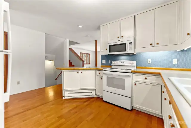 Kitchen has new appliances. Microwave, Dishwasher. New Refrigerator and Electric Range/Oven. Hardwood Cherry floor. Great cabinet storage for Fixtures, Kitchen gadgets and implements.