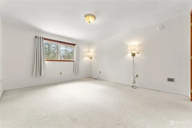 Primary bedroom on upper level of home has wall to wall carpet. Well lit and large south window for natural light. Large closet. Electric heat forced air.