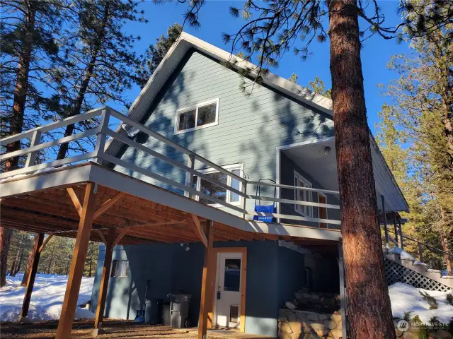 Solid wood deck on South side of home includes a 2 car Carport with ground level door to large mud room. Utility room has additional shelving and storage along with New Washer/ Dryer. Hot water tank has easy access.
