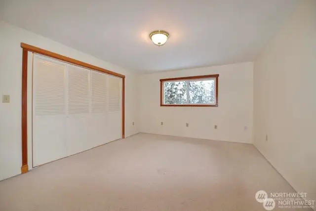 Primary bedroom is carpeted with large closet. Natural light on south side of home comes through the window for refreshing relaxed space.