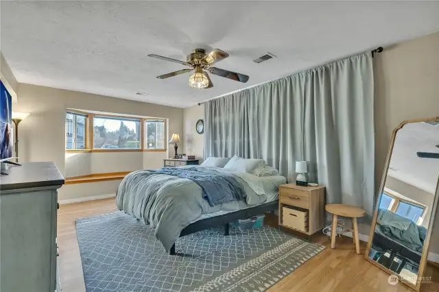 The primary bedroom has so much space! The window seat on the east side is a wonderful place to sit with your morning coffee/tea and read/relax.