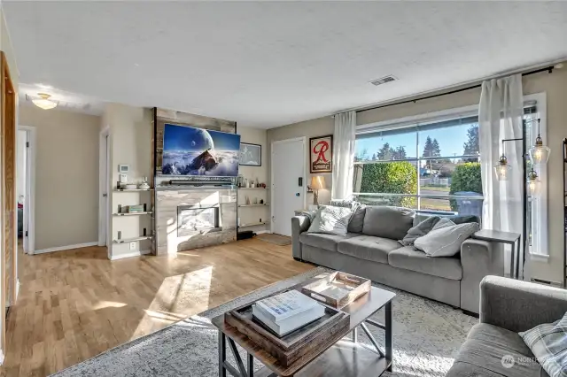 Here you will see the gas fireplace with the shiplap surround decor and shelving on each side. The two secondary bedrooms are just down the hallway.