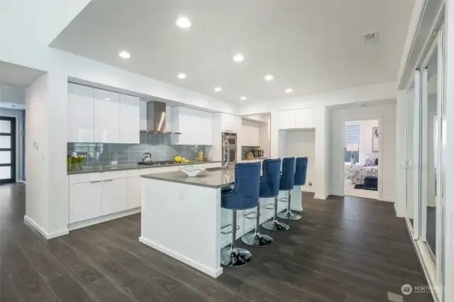 Designer kitchen with view of downstairs bedroom (that has a full bath).