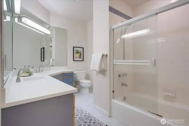 Upstairs hall bathroom with tiled floors and quartz vanity.
