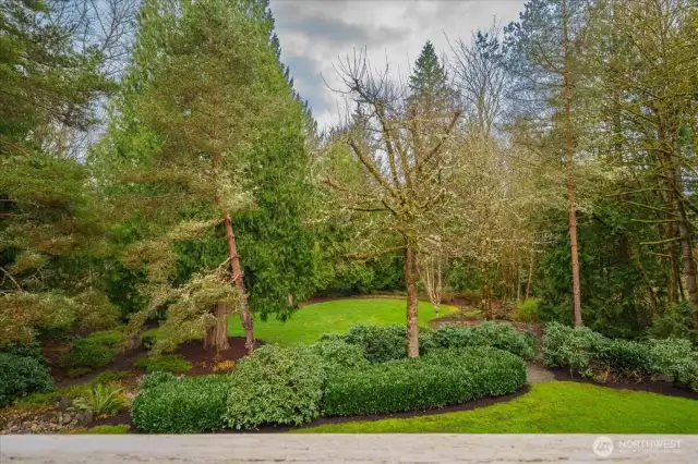The tiered backyard features extensive stonewalling, 3 dry riverbeds, gravel walk ways, 3 raised garden beds with irrigation, 120-V lighting, sprinklers, an electric outlet in the lower yard, invisible fencing and backs to greenbelt.