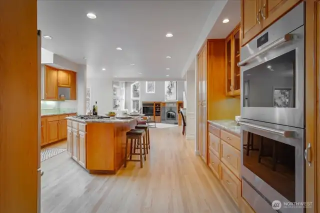 The updated kitchen boasts cherry cabinetry with a natural finish, slab granite counters and tumbled marble back splash.